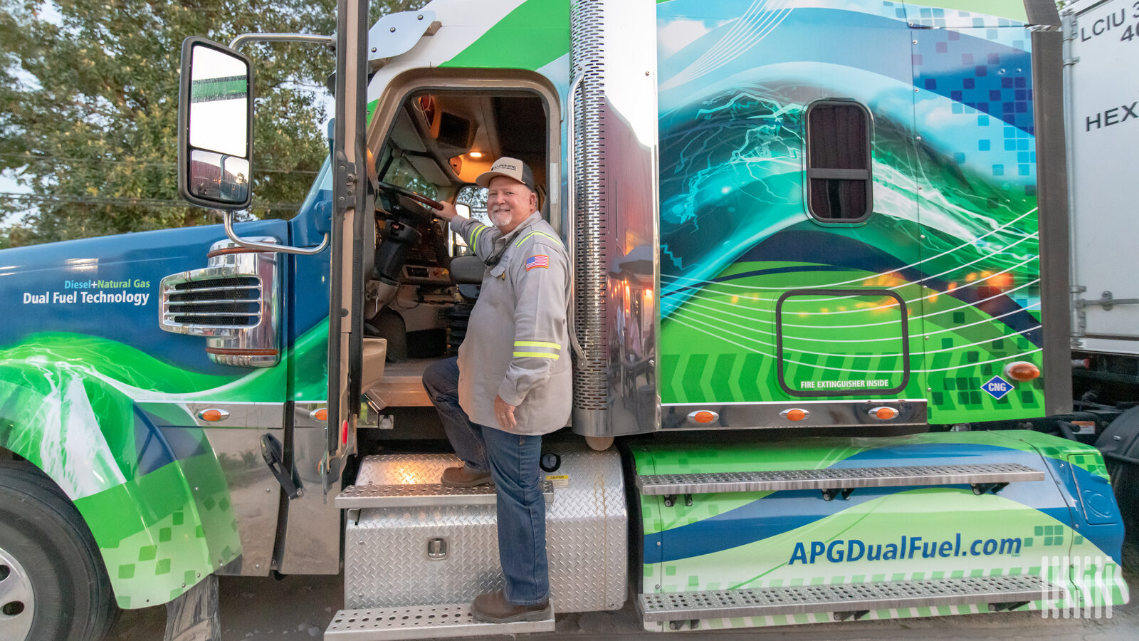 Truck driver climbing into the cab of his truck